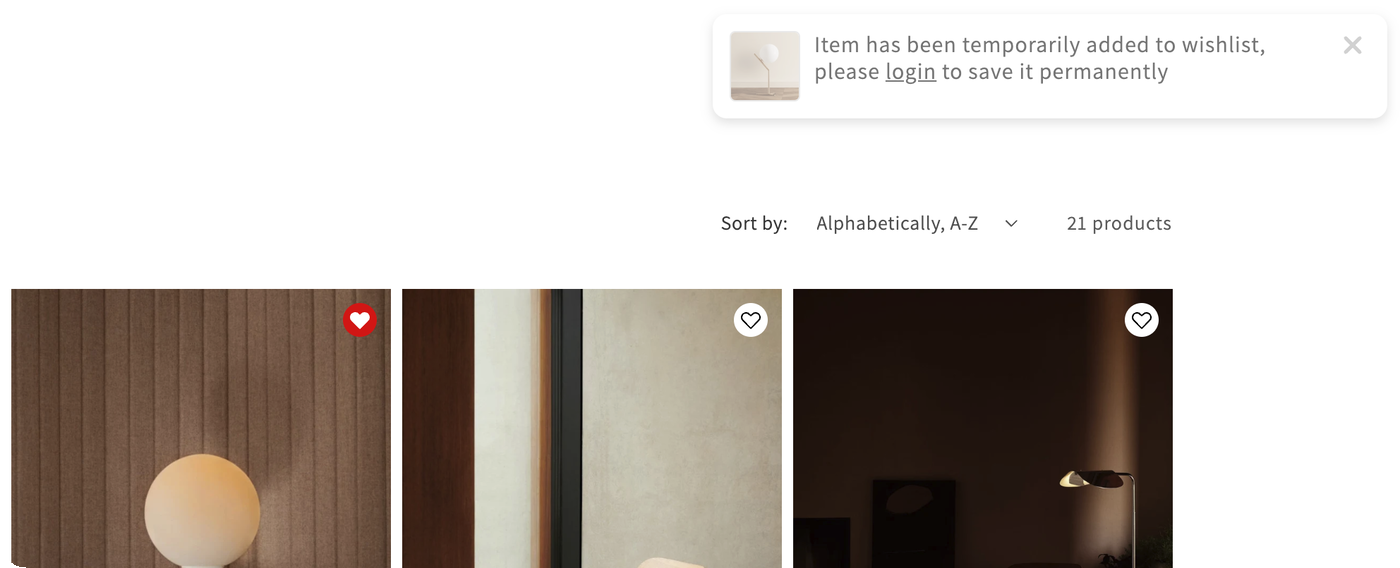 An "Added to wishlist" popup in the top-right corner of the storefront